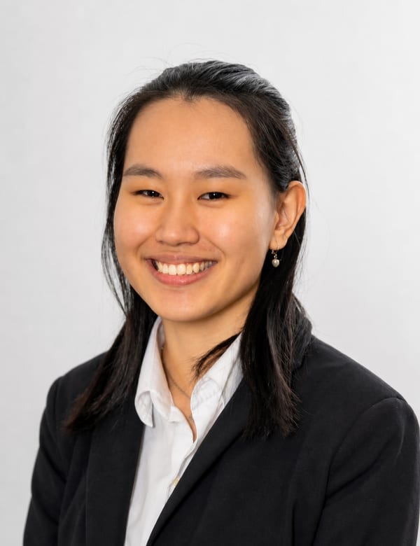 Professional portrait of Phylicia Saputra in a black blazer and white shirt
